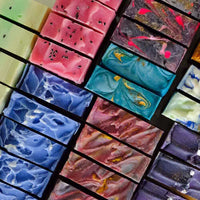 Colorful handmade soap bars in various swirls and patterns, showcasing beauty and creativity in soap making.