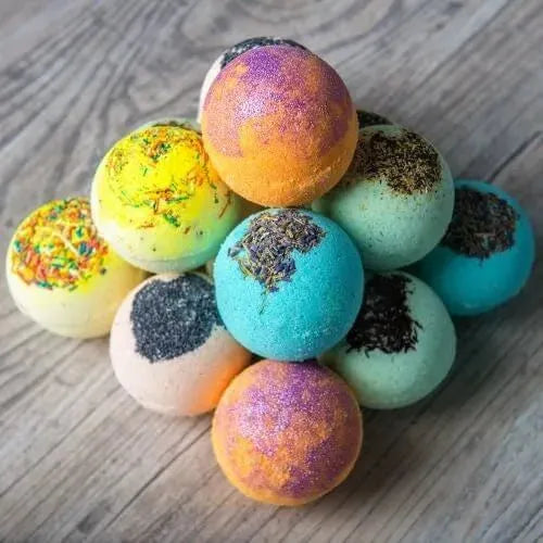 Colorful bath bombs in vibrant hues stacked playfully, showcasing a variety of textures and colors.