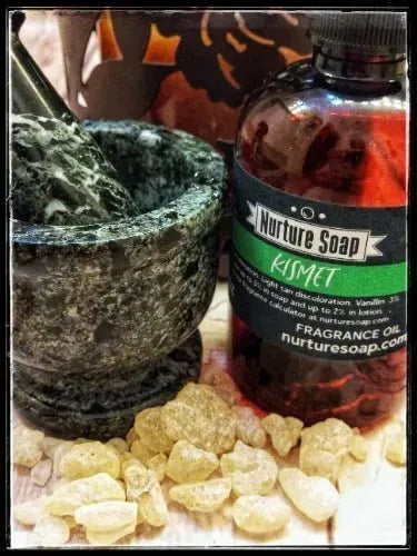Mortar and pestle with Nurture Soap's Kismet fragrance oil and resin pieces, perfect for crafting cold process soap.