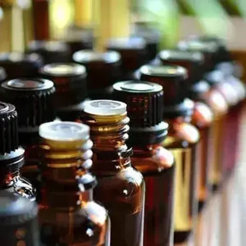 Collection of amber fragrance sample bottles showcasing aromatic essences in various sizes.