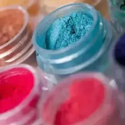 Vibrant mica powders in jars featuring blue, pink, and red shades for creative projects.