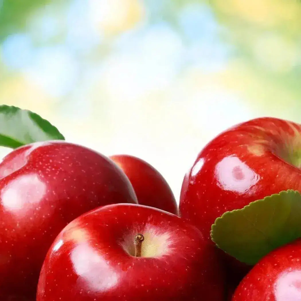 Vibrant red apples with green leaves, showcasing freshness and a delightful apple aroma.