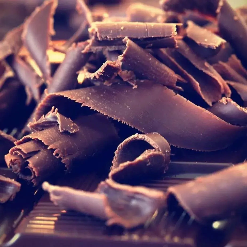 Close-up of rich, dark chocolate shavings perfect for enhancing desserts and creating indulgent aromas.
