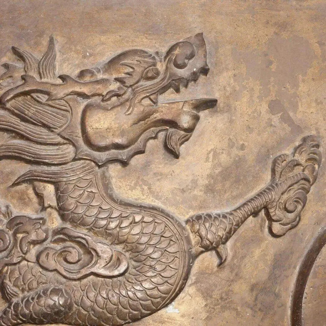 Intricate carving of a dragon surrounded by swirling clouds, showcasing ancient artistry and mystical themes.
