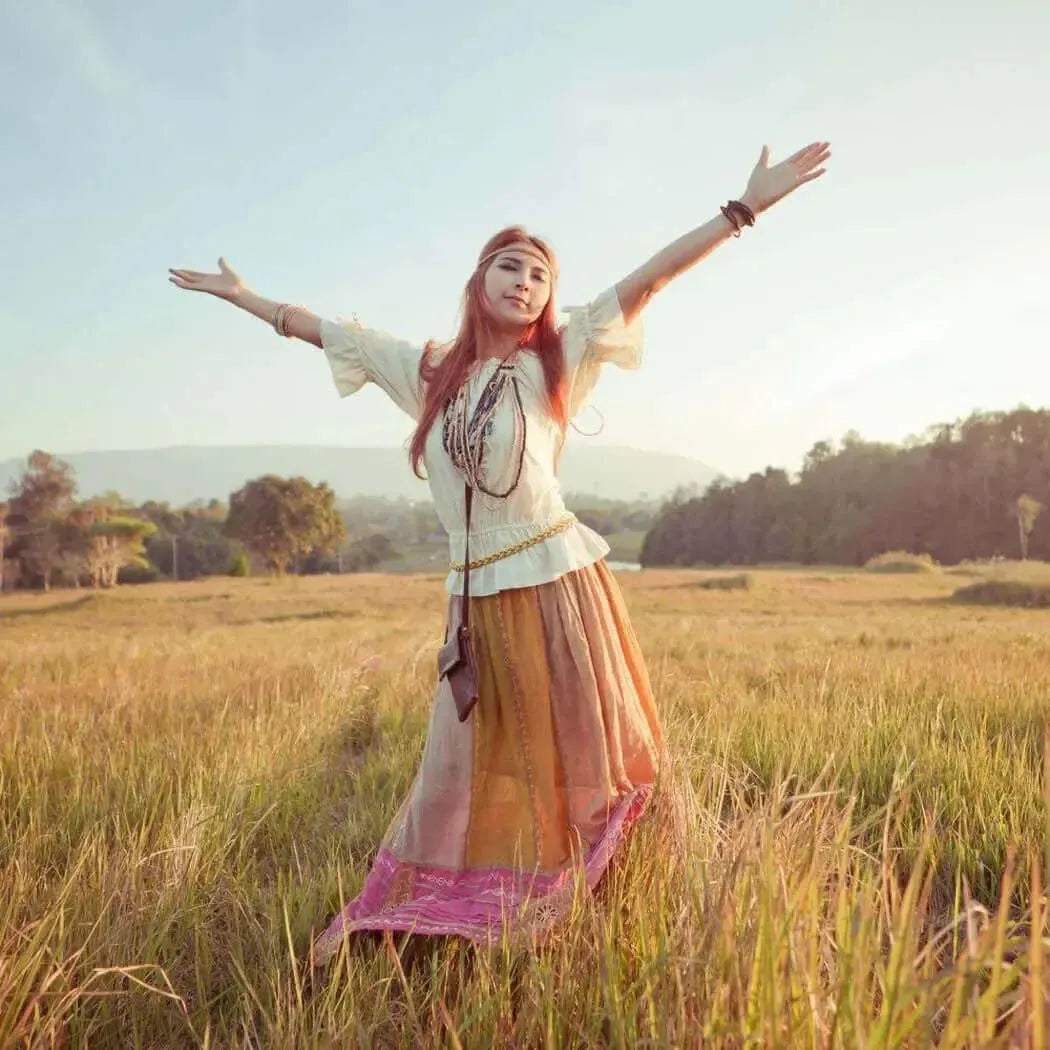 Free-spirited woman in a colorful skirt enjoying nature, embodying freedom and authenticity.