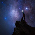 Person silhouetted against a starry night sky, symbolizing a celestial journey and cosmic exploration.