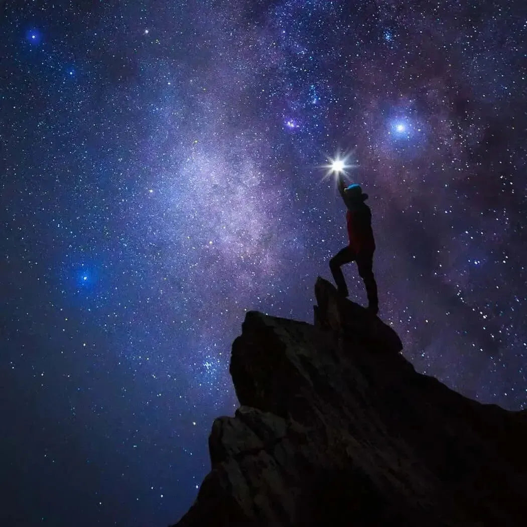 Person silhouetted against a starry night sky, symbolizing a celestial journey and cosmic exploration.