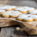 Golden sugar cookies with powdered sugar dusting, reminiscent of homemade treats fresh from Grandma's kitchen.